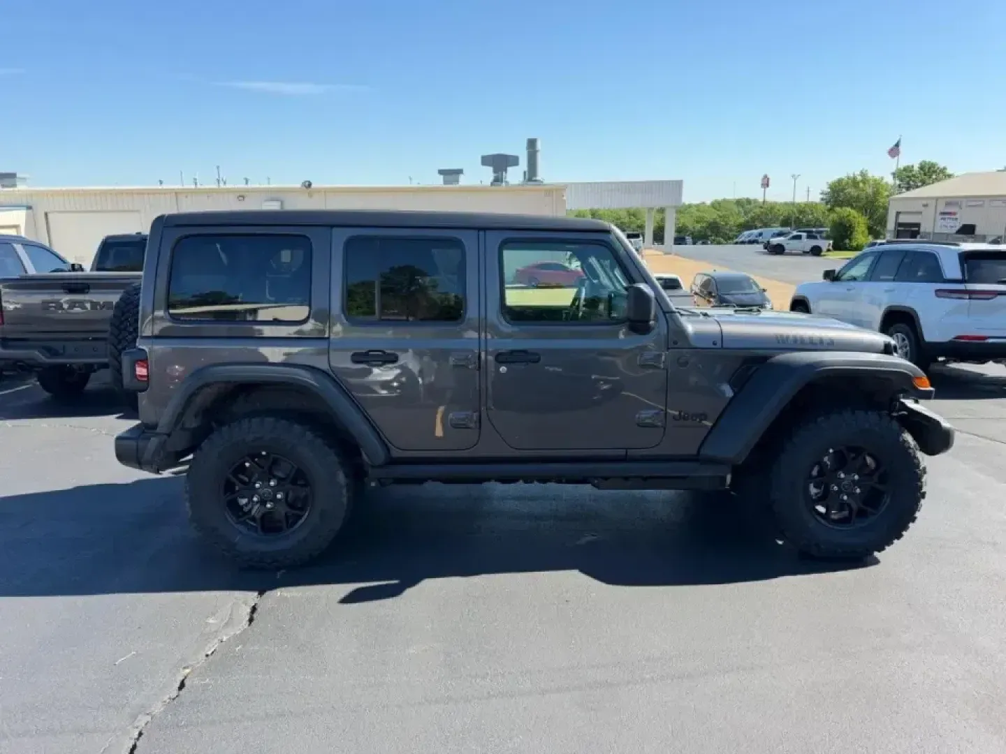 2026 /Black Cloth Jeep Wrangler Willys (1C4PJXDNXTW) with an 2.0L engine, 6M transmission, located at 970 Woodlawn Dr., Farmington, MO, 63640, (573) 431-7800, 37.825642, -90.468674 - Weekend trail runs at St. Joe State Park, a top-down cruise through downtown Farmington, or a confident commute out toward Park Hills and Bonne Terre-this 2026 Jeep Wrangler Sport is built for the kind of life that doesn't stay on pavement. With only **5 miles** on the odometer, it delivers that new - Photo#1